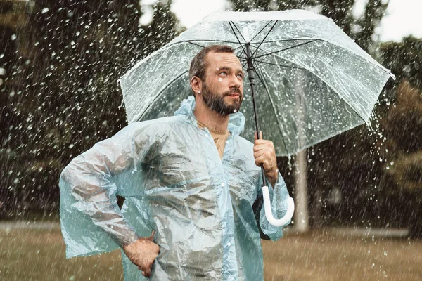 Attractive man strolling in rain — Stock Photo, Image