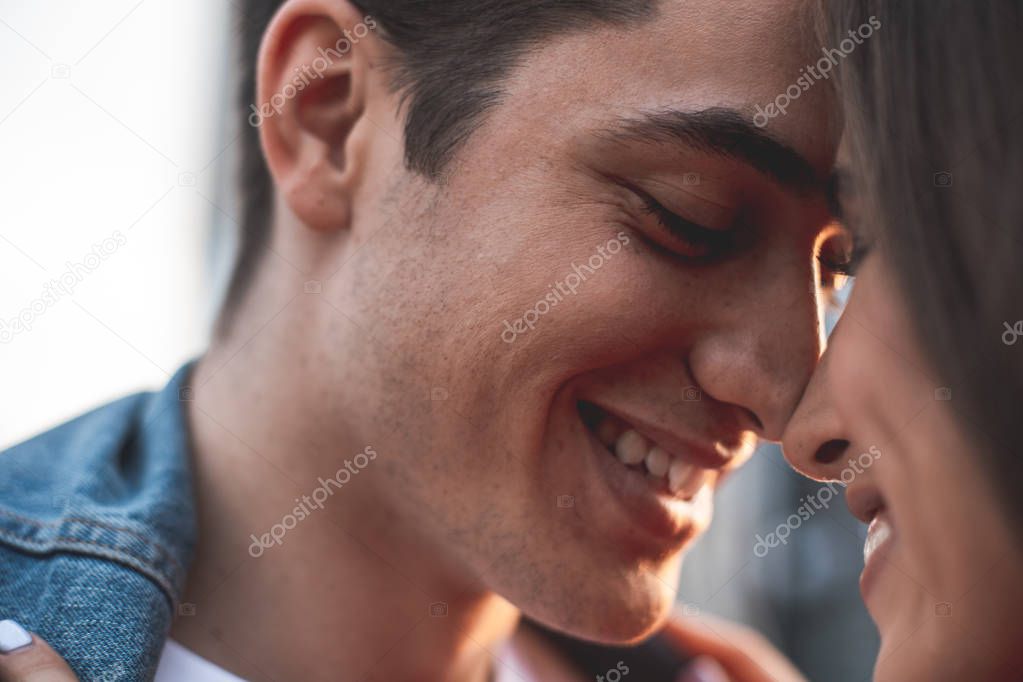 Smiling man holding girlfriend with love