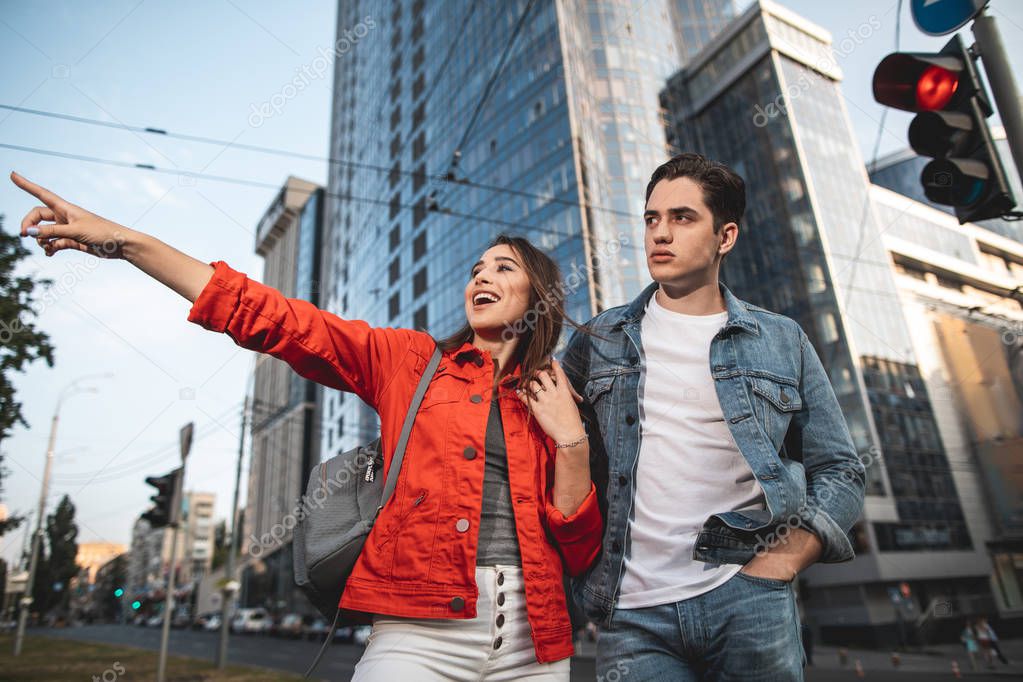 Delighted couple sightseeing in city