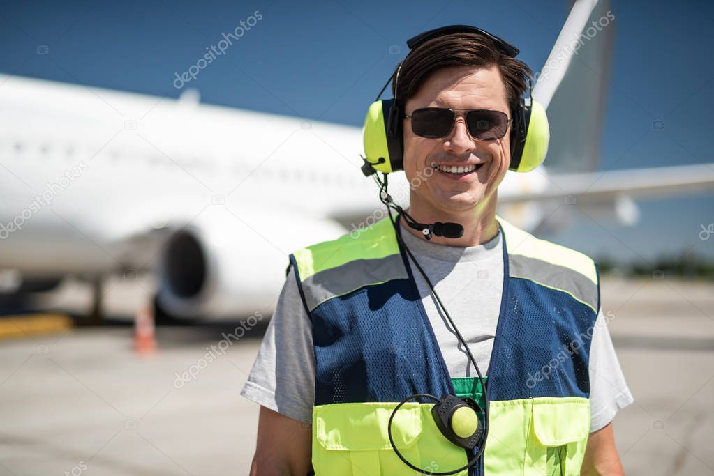 Smiling airport worker on blurred background