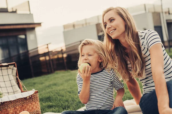 Beaming lady and optimistic kid during picnic — Stock Photo, Image