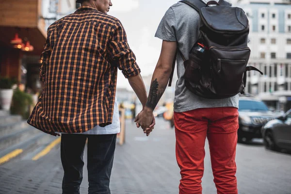 Calm male keeping hand of comrade outdoor — Stock Photo, Image