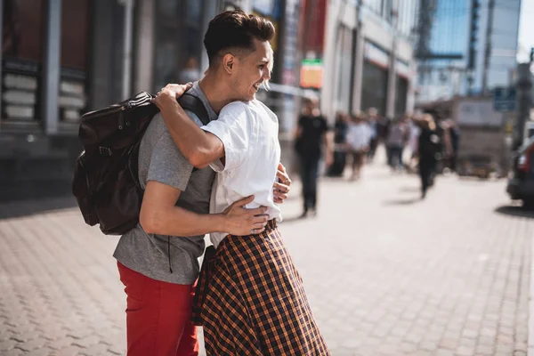 Widok Boku Uśmiechający Się Facet Tulenie Towarzysz Podczas Walk Mieście — Zdjęcie stockowe