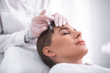 Kapalı gözler güzellik salonunda cilt bakım tedavi gören genç kadınla