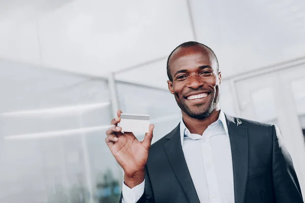 Happy man showing his new plastic card — Stock Photo, Image