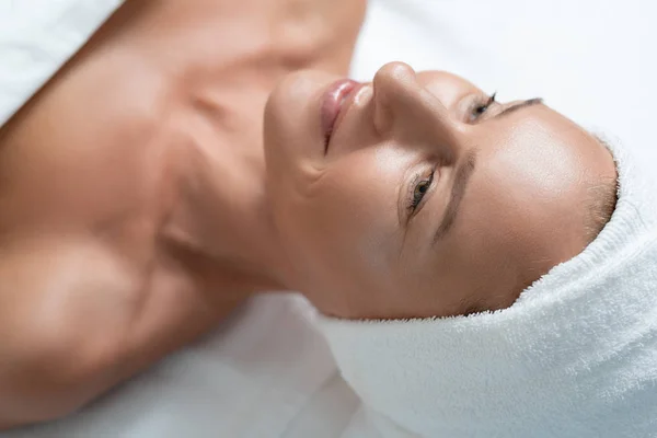 Attractive middle aged woman lying on massage table — Stock Photo, Image