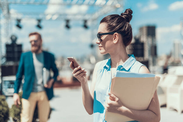 Orderly female worker sending message on mobile