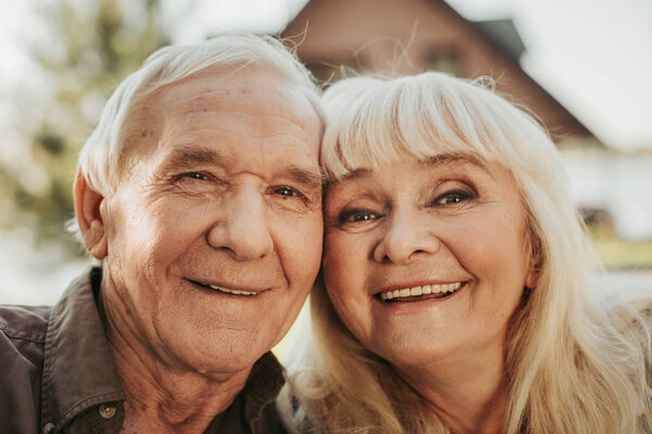 Portrait of cheerful aged man and woman