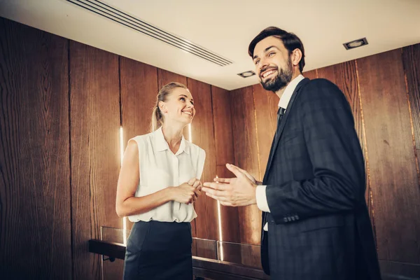 Pleased man telling with positive lady inside — Stock Photo, Image