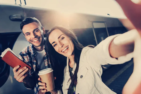 Optimistic girl and cheerful male taking selfie — Stock Photo, Image