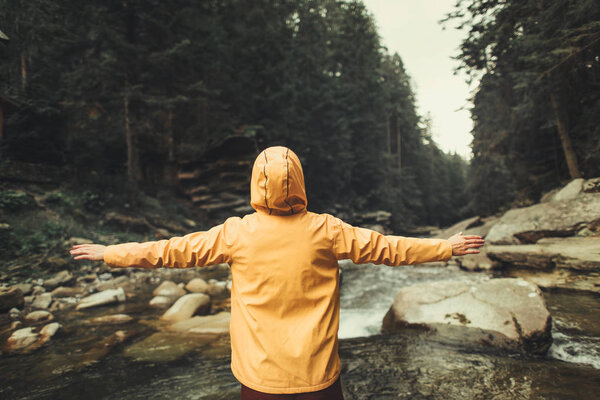 Waist up of an active woman standing in the forest