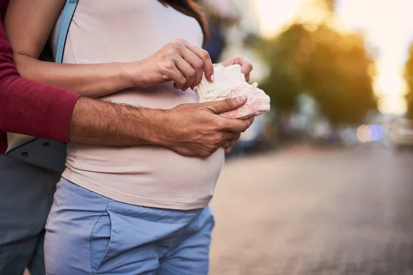 Tutan genç bekleyen ebeveynler Bebek Patiği örme — Stok fotoğraf