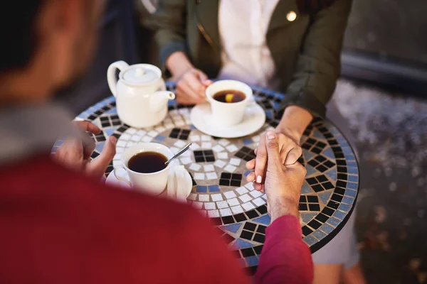 Lovely couple holding hands while spending time in outdoor cafe — Stock Photo, Image