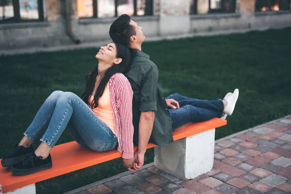 Calm woman closing her eyes and leaning to the back of boyfriend — Stock Photo, Image