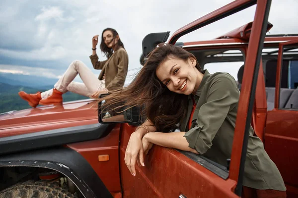 Atractiva mujer sonriente usando su coche todoterreno — Foto de Stock