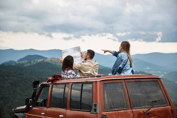 Молодые амбициозные туристы организуют свой маршрут в горах — стоковое фото