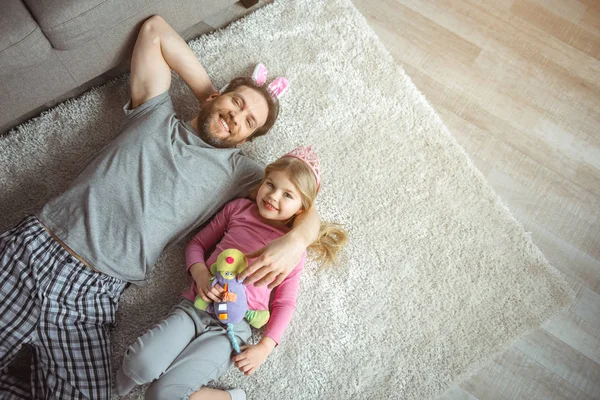 Feliz padre abrazando a su hijo en el suelo — Foto de Stock