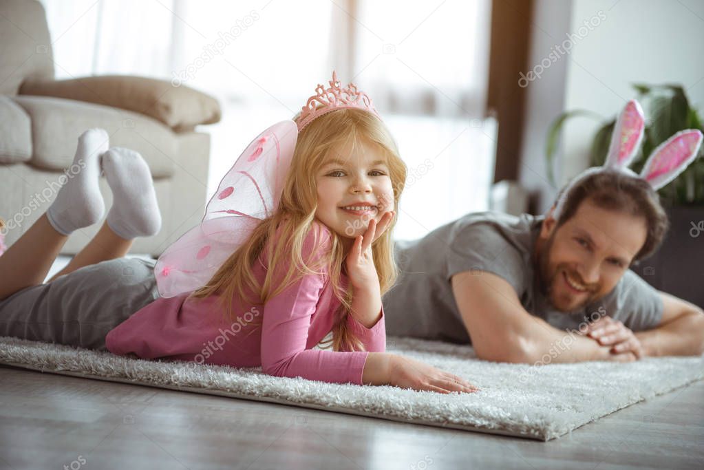 Happy child playing games together with her daddy 