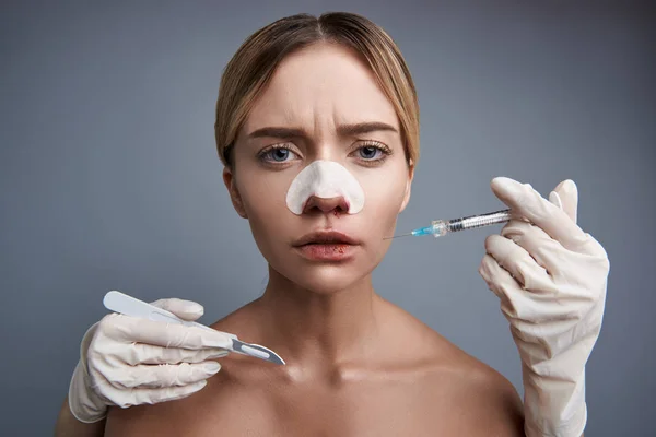 Kimerült hölgy néz rád, miközben megy keresztül a plasztikai sebészet — Stock Fotó