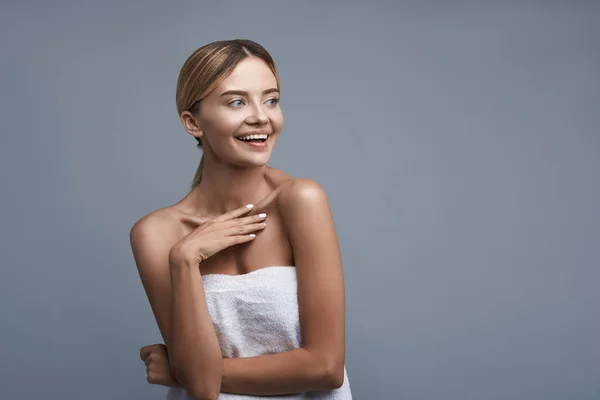 Happy lady laughing while wearing white towel — Stock Photo, Image