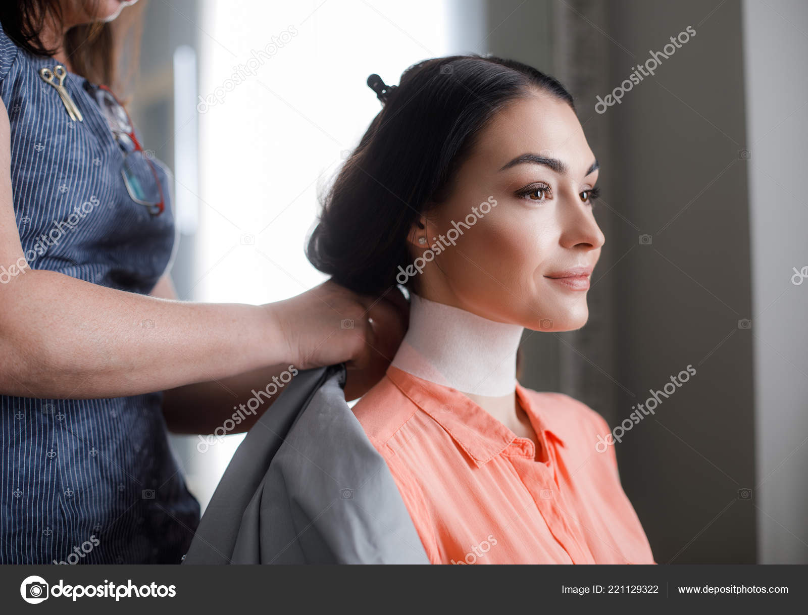 Smiling Woman Is Trimming Hair In Beauty Studio Stock Photo