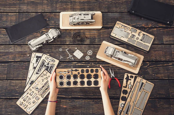 Top view of female hands holding parts of the constructor — Stock Photo, Image