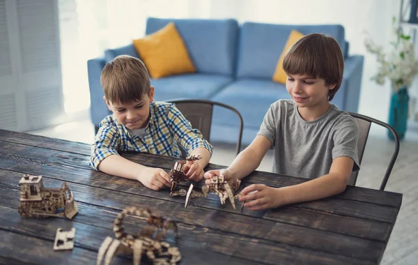 Rapazes amigáveis sorrindo enquanto brincam na mesa juntos — Fotografia de Stock