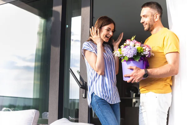 Beautiful woman surprised by present from handsome man