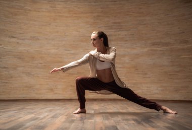 Onun diz bükme ve chi gong antrenman sırasında omzuna bir el koyarken mesafe içine bakarak sakin ince genç bayan