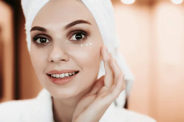 Jovem mulher cremoso seu rosto após o chuveiro — Fotografia de Stock