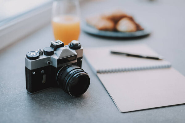 Selective focus of a photo camera lying on the table