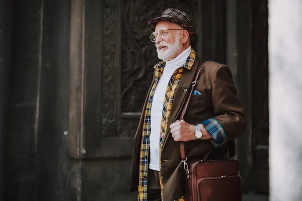 Cheerful stylish old man is looking somewhere — Stock Photo, Image