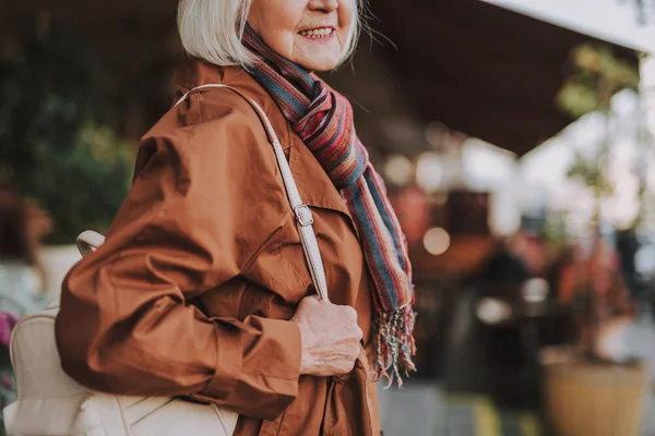 Elegante anciana con mochila posando en la calle — Foto de Stock
