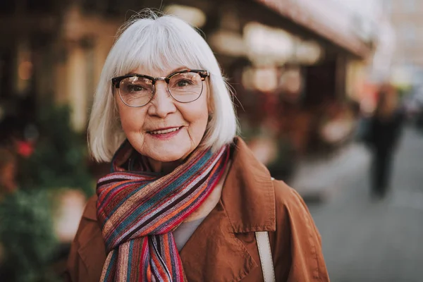 Mujer mayor alegre en gafas posando al aire libre — Foto de Stock