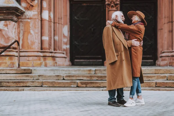 Beautiful senior couple hugging on the street