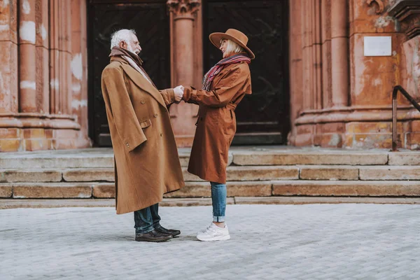 Beautiful elderly couple holding hands on the street