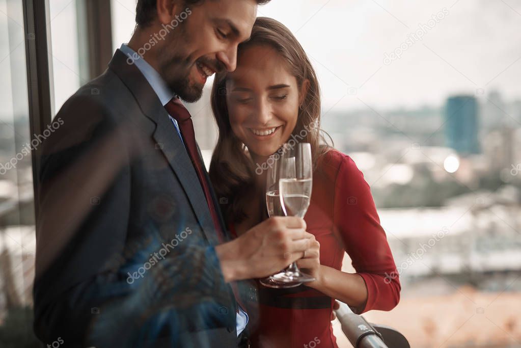 Man and woman celebrating with champagne glasses