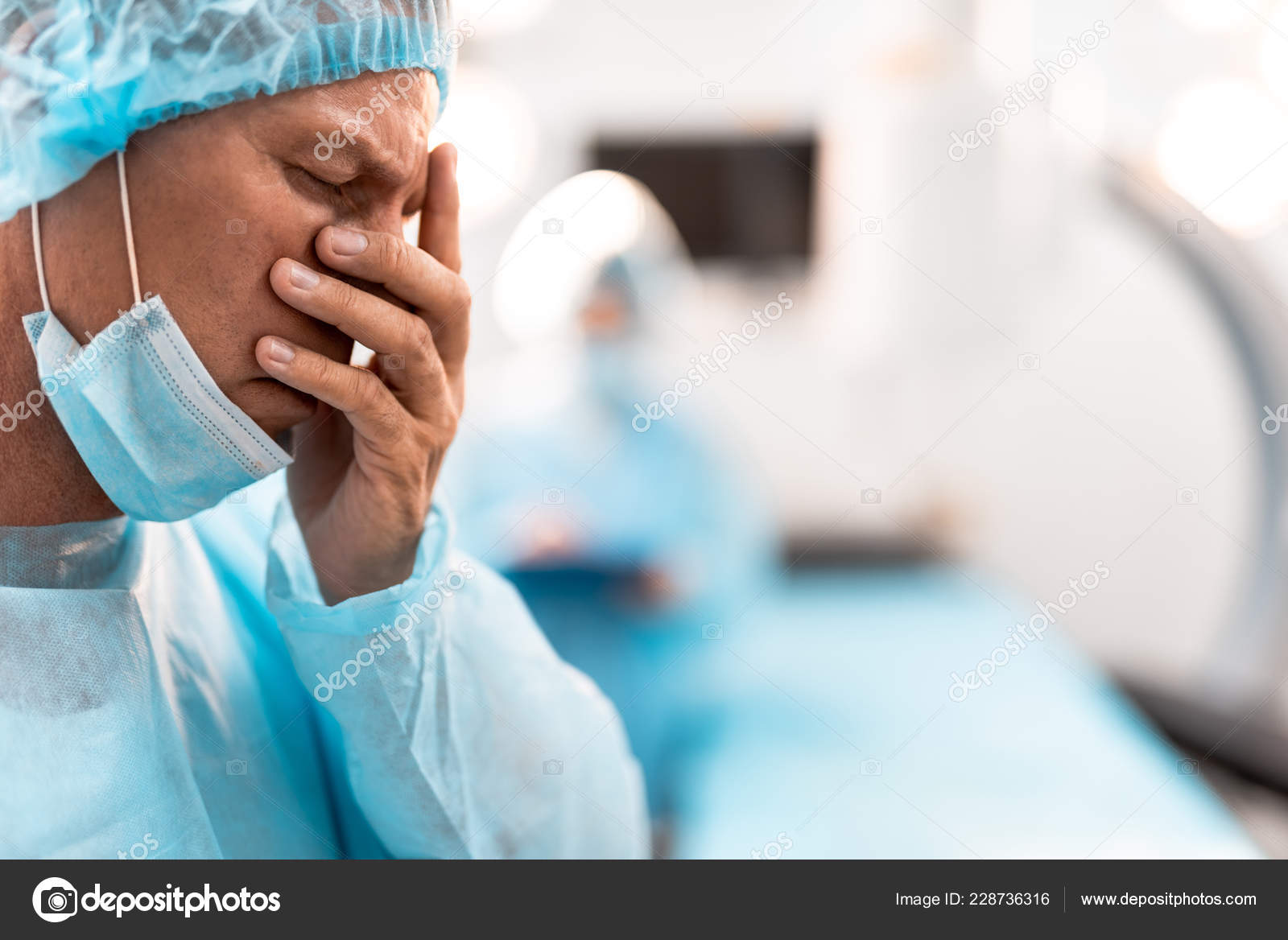 Exhausted doctor closing his eyes after having difficult day Stock