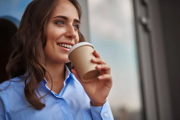 Female worker drinking coffee on office balcony — Stock Photo, Image