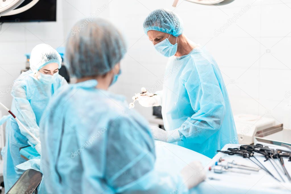 Surgeon using laparoscopic instrument during surgical operation