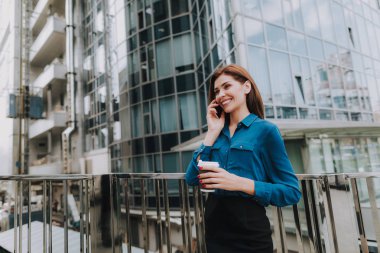 Biraz ara iş kavramı. Kahve iş merkezi yakınlarındaki ile telefonla konuşurken neşeli şık kadın portresi kadar bel. Kopya alanı solda