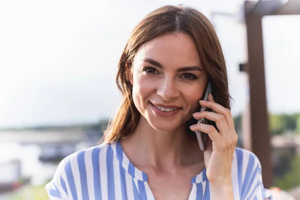 Happy smiling lady using phone for conversation