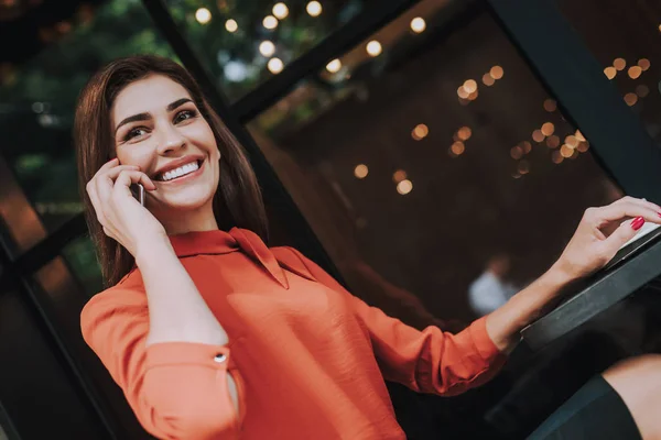 Smiling business woman talking by mobile phone