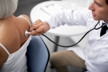 Dikkat et Doktor stetoskop hasta arkasına yerleştirerek