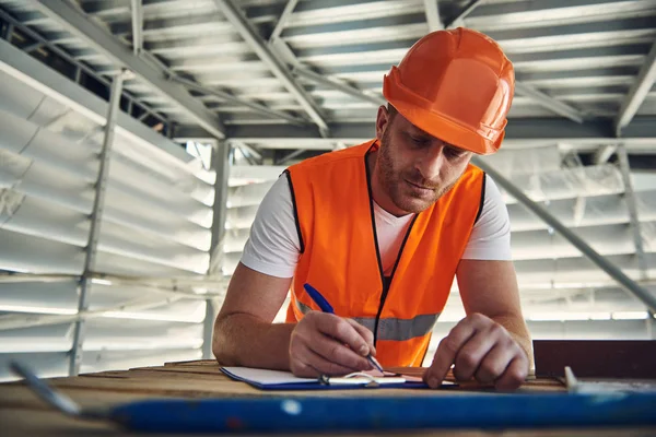 Worker man in helmet is working on construction site — Stock Photo, Image