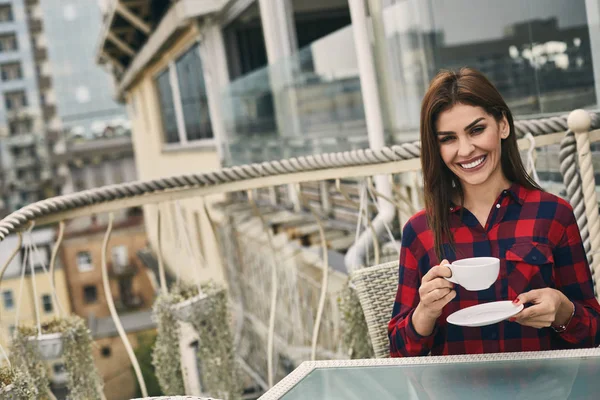 Happy woman is drinking tea on terrace — Stock Photo, Image