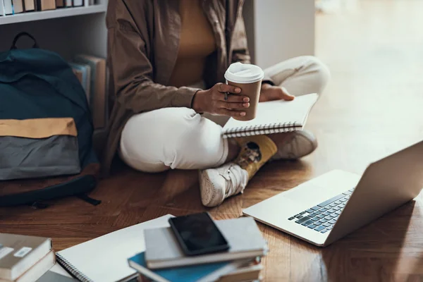 Крупним планом студент сидить з нотатками кави і сучасного ноутбука — стокове фото
