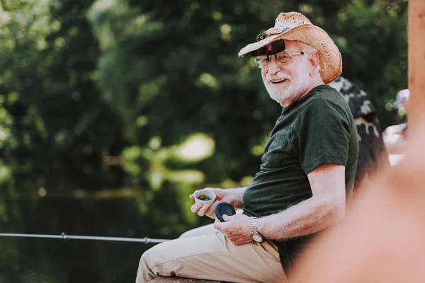 Cheerful aged man enjoying his fishing weekend — Stock Photo, Image