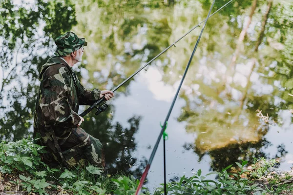 Rear view of a retired angler having fishing weekend — Stock Photo, Image