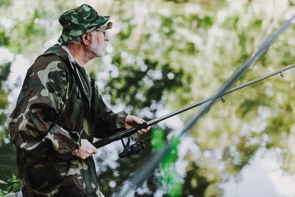 Waist up of a retired angler fishing on the weekend — Stock Photo, Image